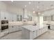 Bright, modern kitchen featuring white cabinetry, an island, and stainless steel appliances at 9357 W Canyon Verde Dr, Casa Grande, AZ 85194