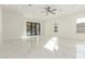 Bright living room showcasing marble floors, a ceiling fan, and sliding glass doors to the outside at 9357 W Canyon Verde Dr, Casa Grande, AZ 85194