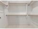 Spacious walk-in closet with white shelving and racks, offering ample storage space at 9357 W Canyon Verde Dr, Casa Grande, AZ 85194