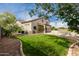 Spacious backyard with a well-manicured lawn, and swimming pool perfect for outdoor entertaining at 9825 E Gary St, Mesa, AZ 85207