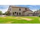 Two-story home backyard with a large lawn, patio, and grill area at 9825 E Gary St, Mesa, AZ 85207