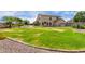 Two-story home backyard with a large lawn, patio, grill area and lush landscaping at 9825 E Gary St, Mesa, AZ 85207