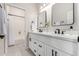 Bright bathroom featuring double sinks, quartz countertops, and framed mirrors at 9825 E Gary St, Mesa, AZ 85207