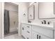 Bright bathroom featuring double sinks, quartz countertops, and framed mirrors at 9825 E Gary St, Mesa, AZ 85207