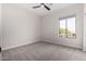 Cozy bedroom with neutral walls and a bright window showing exterior views at 9825 E Gary St, Mesa, AZ 85207