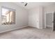 Neutral bedroom with carpet flooring, fan, large window, and a closet with sliding doors at 9825 E Gary St, Mesa, AZ 85207
