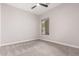 Neutral bedroom with carpet flooring, fan, and a large window at 9825 E Gary St, Mesa, AZ 85207