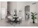 Bright dining area features high ceilings, modern table and decor, and stairs to the second floor at 9825 E Gary St, Mesa, AZ 85207