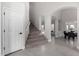 Bright foyer with an arched entryway, staircase, neutral paint, and light tile floors at 9825 E Gary St, Mesa, AZ 85207
