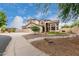 Inviting two-story home featuring a three-car garage, desert landscaping, and a well manicured front yard at 9825 E Gary St, Mesa, AZ 85207