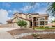 Inviting two-story home featuring a three-car garage, desert landscaping, and a well manicured front yard at 9825 E Gary St, Mesa, AZ 85207