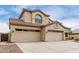 Inviting two-story home featuring a three-car garage, desert landscaping, and a tile roof at 9825 E Gary St, Mesa, AZ 85207