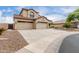 Beautiful two-story home showcasing a three-car garage, desert landscaping, and ample parking space at 9825 E Gary St, Mesa, AZ 85207