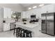 Contemporary kitchen with stainless steel appliances, island seating, and sleek white cabinets at 9825 E Gary St, Mesa, AZ 85207