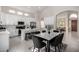 Bright, open kitchen featuring an island, stainless steel appliances, and a cozy dining area at 9825 E Gary St, Mesa, AZ 85207