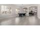 Bright, open living room with a billiards table and arched doorways leading to other living areas at 9825 E Gary St, Mesa, AZ 85207