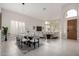 Bright and airy living and dining area with modern lighting, tile floors and view to exterior at 9825 E Gary St, Mesa, AZ 85207