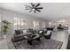 Spacious living room featuring a ceiling fan, modern furniture, and an adjacent dining area at 9825 E Gary St, Mesa, AZ 85207