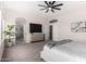 Spacious main bedroom with a ceiling fan, natural light, and en-suite bathroom with a glass shower at 9825 E Gary St, Mesa, AZ 85207