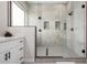 Stylish glass shower with gray tile, modern fixtures, built-in shelves, and a sleek shower head at 9825 E Gary St, Mesa, AZ 85207