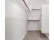 Walk-in closet featuring built-in shelves and rods for ample storage space at 9825 E Gary St, Mesa, AZ 85207