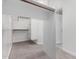 Walk-in closet with carpeted floor, wooden railing, white shelves, and a bright interior at 9825 E Gary St, Mesa, AZ 85207