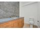 Bathroom featuring a wooden vanity with decorative backsplash at 100 W Northern Ave # 7, Phoenix, AZ 85021