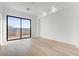 Modern bedroom with large window, hardwood floors, and minimalist style at 100 W Northern Ave # 7, Phoenix, AZ 85021