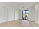 Bedroom featuring hardwood floors and a large window at 100 W Northern Ave # 7, Phoenix, AZ 85021