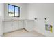 Bright laundry room with white cabinets and plenty of counter space at 100 W Northern Ave # 7, Phoenix, AZ 85021