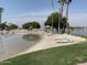 Picturesque beach front with lounge chairs near the water at 1010 N Osprey Ct, Gilbert, AZ 85234