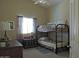 Charming bedroom featuring a bunk bed, vintage trunk, and natural light at 1010 N Osprey Ct, Gilbert, AZ 85234