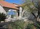 Charming single-story home with a tile roof, private patio, lush landscaping, and inviting curb appeal at 1010 N Osprey Ct, Gilbert, AZ 85234