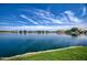 Calm lake with a beautiful sky view, grassy shoreline, and homes along the waterfront at 1010 N Osprey Ct, Gilbert, AZ 85234