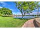 Lush park and waterfront view featuring a walking path, lake, trees, and blue skies at 1010 N Osprey Ct, Gilbert, AZ 85234