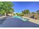 Tranquil swimming pool surrounded by lush landscaping and shaded lounging areas at 1010 N Osprey Ct, Gilbert, AZ 85234