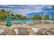 Relaxing pool area with lounge chairs, sandy beach, waterfall, and lush tropical landscaping at 1010 N Osprey Ct, Gilbert, AZ 85234