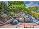 Scenic water feature with cascading waterfalls, lush greenery, and a tranquil ambiance, creating a serene outdoor retreat at 1010 N Osprey Ct, Gilbert, AZ 85234