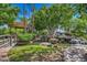 Lush water feature with vibrant landscaping and a tranquil waterfall, creating a serene and inviting atmosphere at 1010 N Osprey Ct, Gilbert, AZ 85234