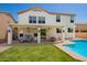 Backyard showcasing a covered patio, green lawn, and a refreshing pool at 1014 W Mulberry Dr, Chandler, AZ 85286