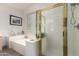 Bright bathroom with a glass door shower, soaking tub, and tile flooring at 1014 W Mulberry Dr, Chandler, AZ 85286