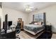 Bedroom features wood-look flooring, ceiling fan, a window, and ample closet space at 1014 W Mulberry Dr, Chandler, AZ 85286