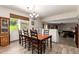 Dining room features a wooden table set for six, with a chandelier and natural light at 1014 W Mulberry Dr, Chandler, AZ 85286