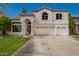 Charming two-story home with a three car garage, well-manicured lawn, and an arched entryway at 1014 W Mulberry Dr, Chandler, AZ 85286