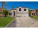 Charming two-story home with a three car garage, well-manicured lawn, and an arched entryway at 1014 W Mulberry Dr, Chandler, AZ 85286