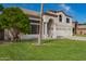 Charming two-story home with a three car garage, well-manicured lawn, and an arched entryway at 1014 W Mulberry Dr, Chandler, AZ 85286
