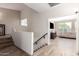 Hallway with staircase, wood flooring, and view into a bright living room at 1014 W Mulberry Dr, Chandler, AZ 85286
