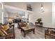 Spacious living room with staircase overlook, beautiful chandelier and stylish leather furniture at 1014 W Mulberry Dr, Chandler, AZ 85286