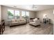 Inviting living room featuring neutral-toned furniture, ceiling fan and bright natural lighting at 1014 W Mulberry Dr, Chandler, AZ 85286