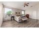 Bright main bedroom featuring a ceiling fan, wood-look flooring, and two windows at 1014 W Mulberry Dr, Chandler, AZ 85286
